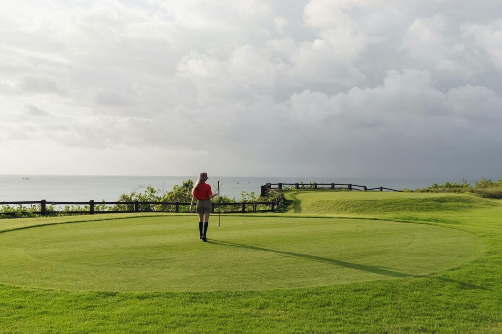 Golfers enjoying a round on the fairway with the ocean in the distance. — Dungeness golf courses