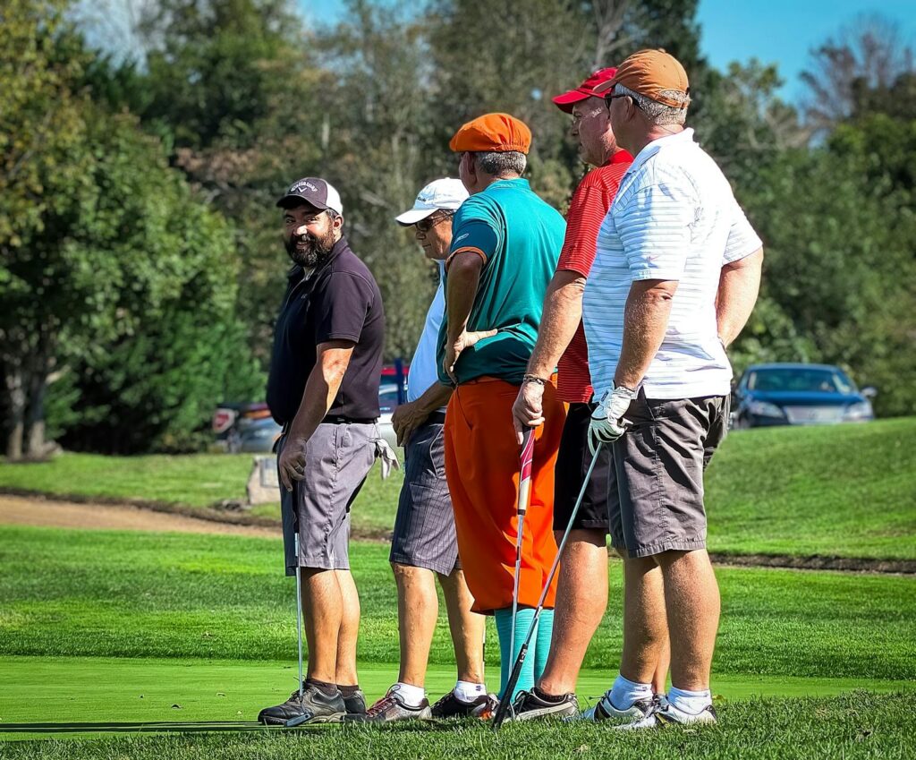 Group of golfers discussing strategies on the course — Dungeness Golf tips