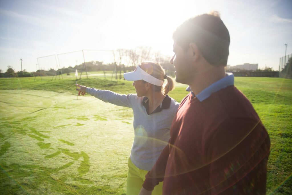 Instructor giving a golf lesson to a beginner on the course — beginner golf Dungeness