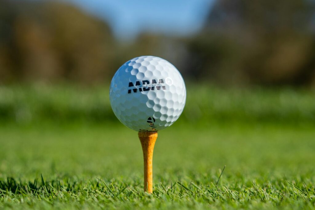 A close-up of a golf ball at tee-off, demonstrating the importance of proper alignment — golf beginner mistakes