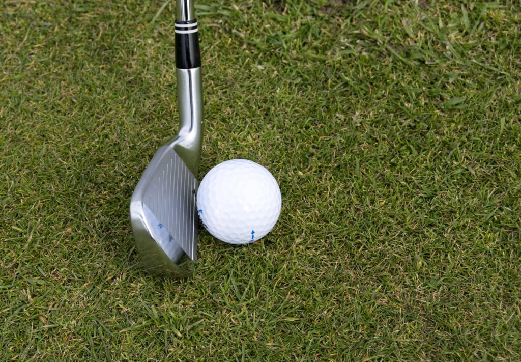 A close-up of a golf ball just before impact with an iron club. — perfect iron shots