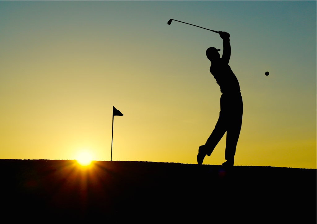 A close-up of a golfer teeing off at Pebble Beach Golf Links, with waves crashing in the background. — best golf courses