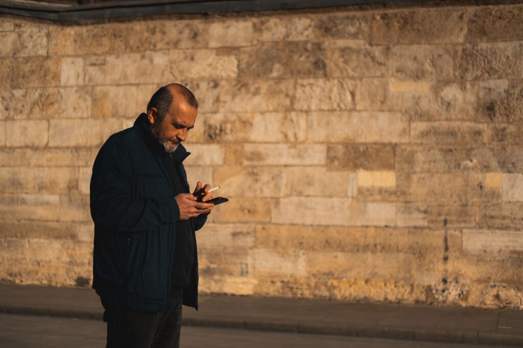 A golfer checking the weather on a mobile device before heading out. — best time to play golf Dungeness