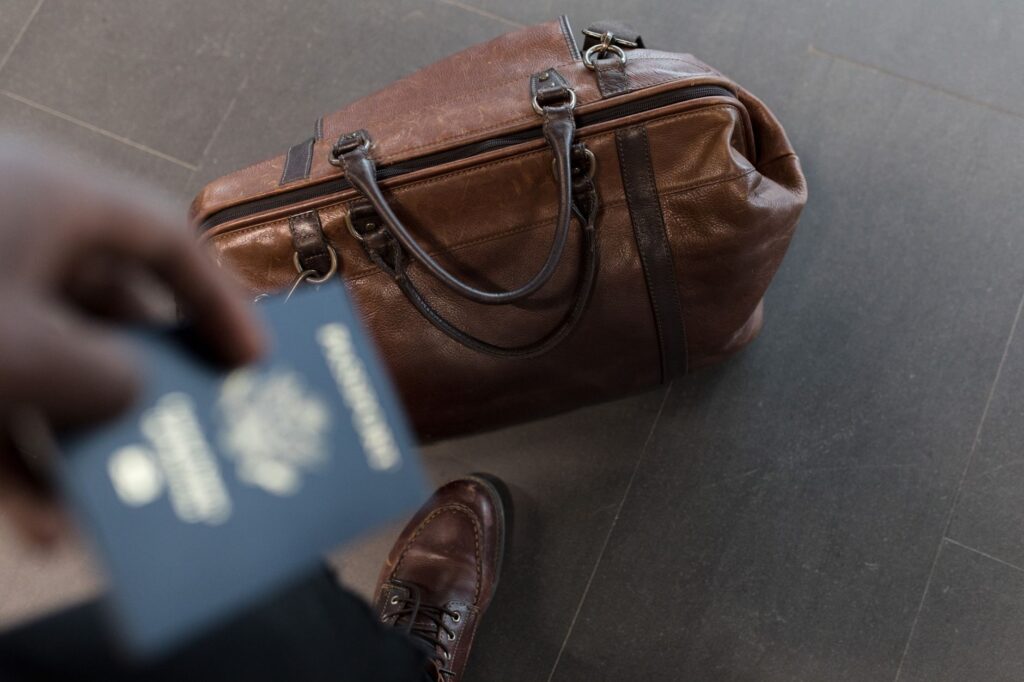 A golfer packing a travel bag at the airport — best golf bags