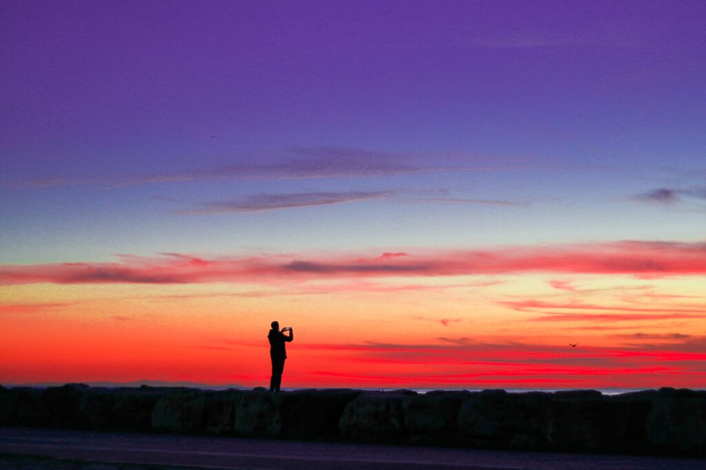 A golfer taking a shot against a stunning sunset backdrop at Dungeness. — Dungeness golf features