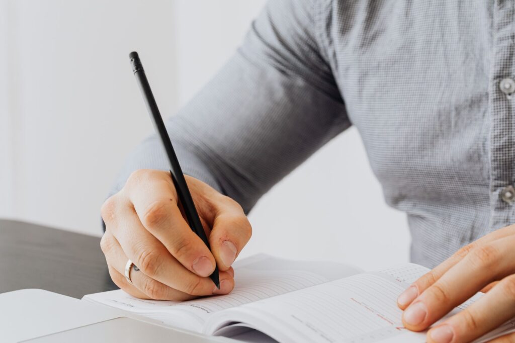 A golfer taking notes on their performance after a round. — how to break 90 in golf