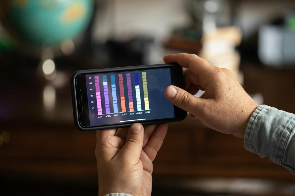 A golfer tracking their short game progress using an app on their smartphone. — short game golf skills