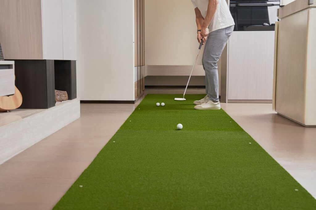 A golfer using a putting arc to work on their stroke at a practice green. — golf practice drills