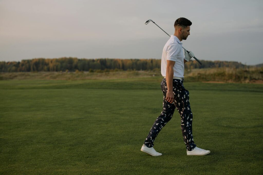 A golfer wearing stylish and functional golf apparel on the course. — golf accessories Dungeness