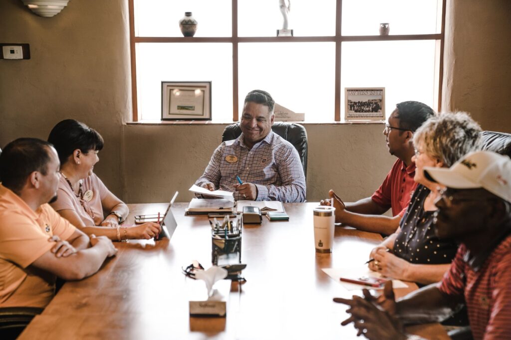 A group of golfers discussing their strategies before a round. — golf course management
