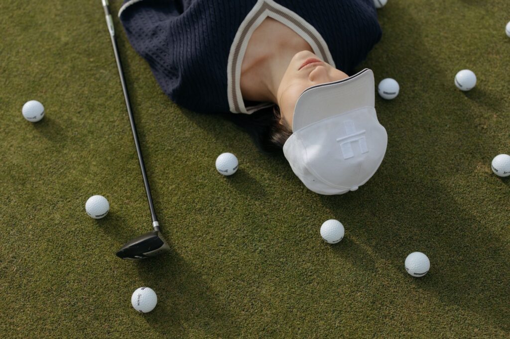 An assortment of recommended Dungeness golf gear laid out on a green grass background. — golf equipment Dungeness