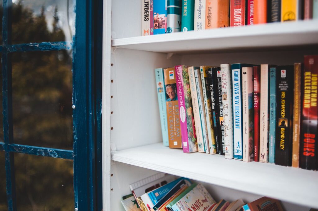 A bookshelf filled with various golf books, showcasing different genres — best golf books