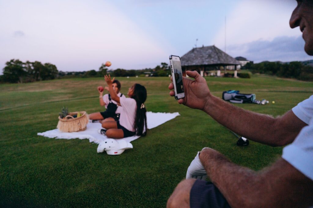 A family capturing memories with a camera while playing golf. — Dungeness Golf family activities