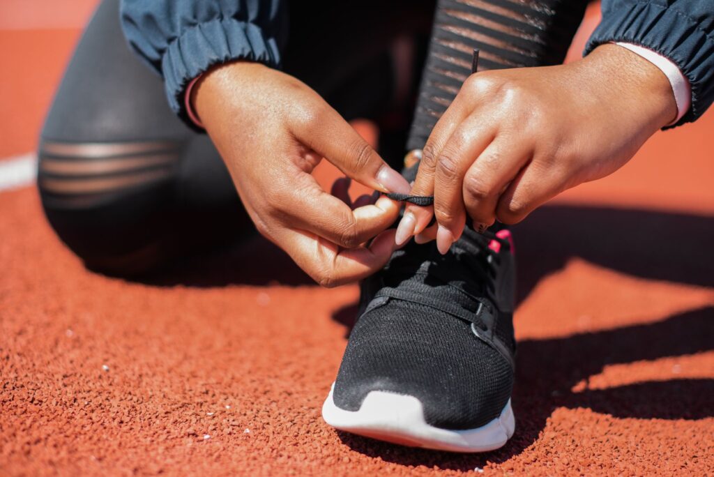 A golfer tying their shoes, showcasing the importance of footwear. — best golf apparel