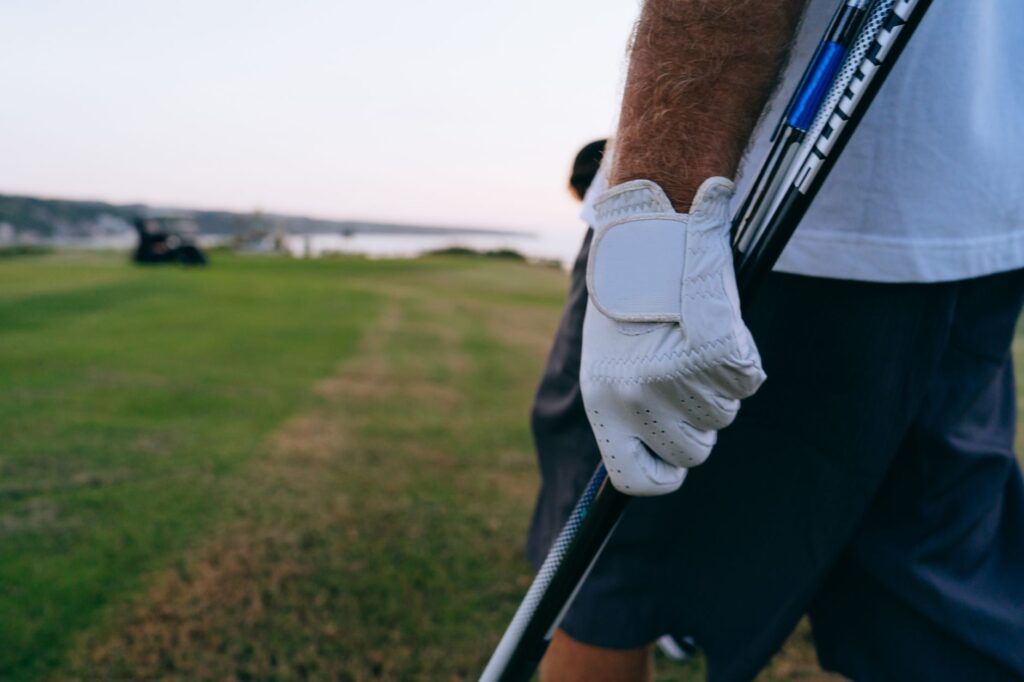 A golfer wearing weather-appropriate gear on a Dungeness course. — golf equipment for Dungeness