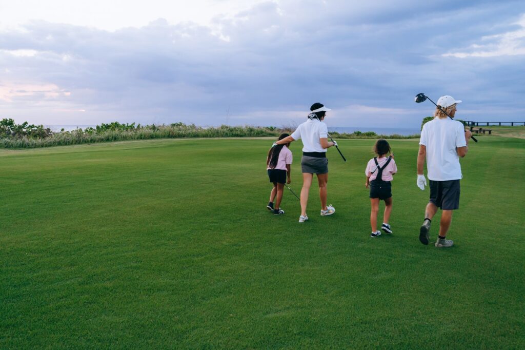 A group of beginner golfers discussing their gear on the course. — best golf hybrids