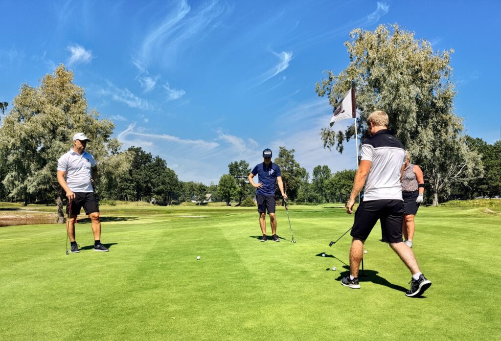 A group of golfers engaging in stretching exercises on the course. — Dungeness golf tips