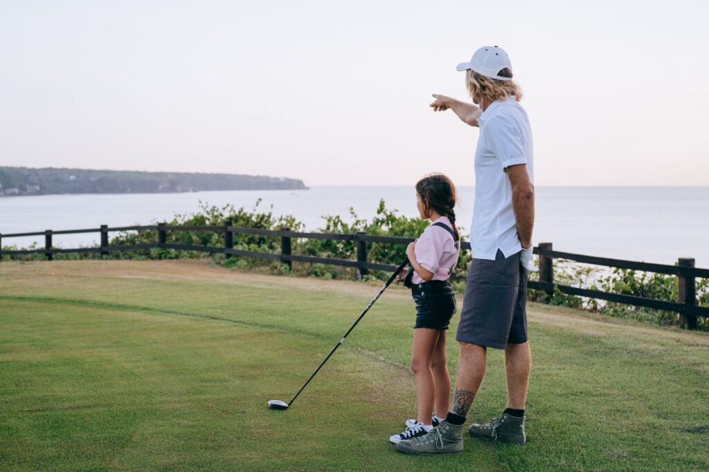 A parent teaching their child the basics of golf, showcasing bonding. — golf for kids