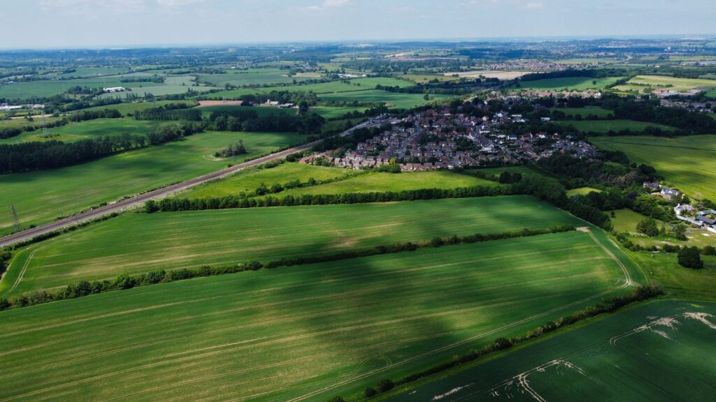 An aerial shot of Dungeness showcasing the lush greens in summer. — best time Dungeness golf