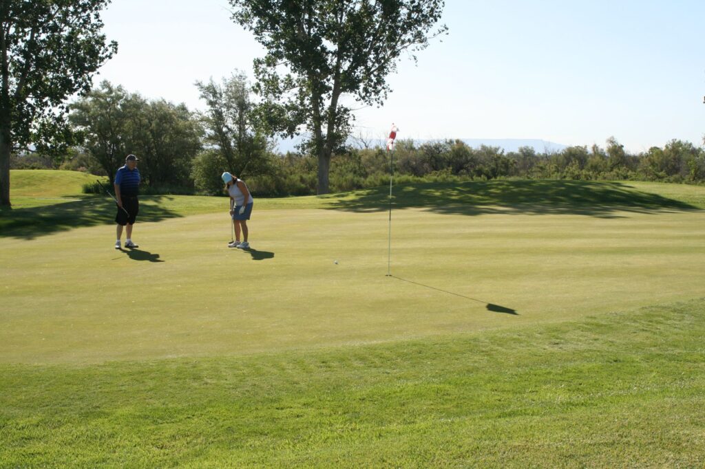 Golfers enjoying a sunny day on the Dungeness fairway during summer — best time to visit Dungeness golf