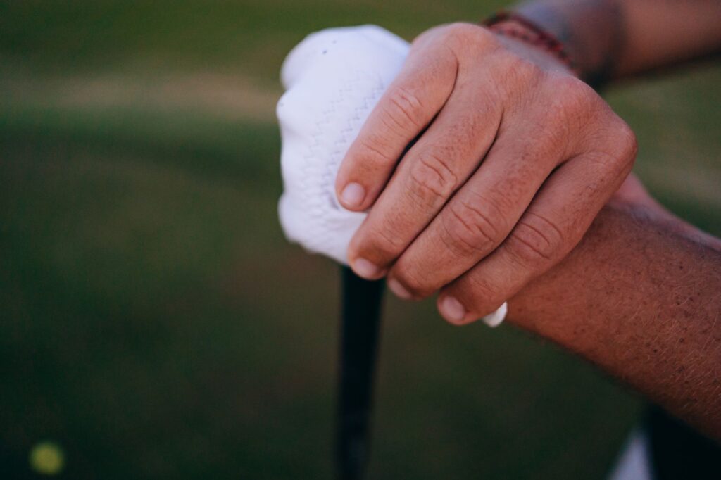 A close-up of a beginner's hands gripping a golf club correctly. — beginner golf Dungeness