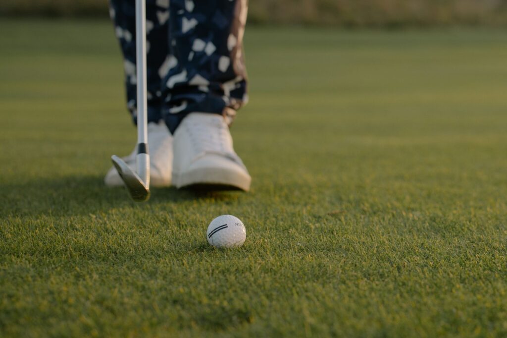 A close-up of a golf club striking the ball on the Dungeness course. — swing tips Dungeness Golf