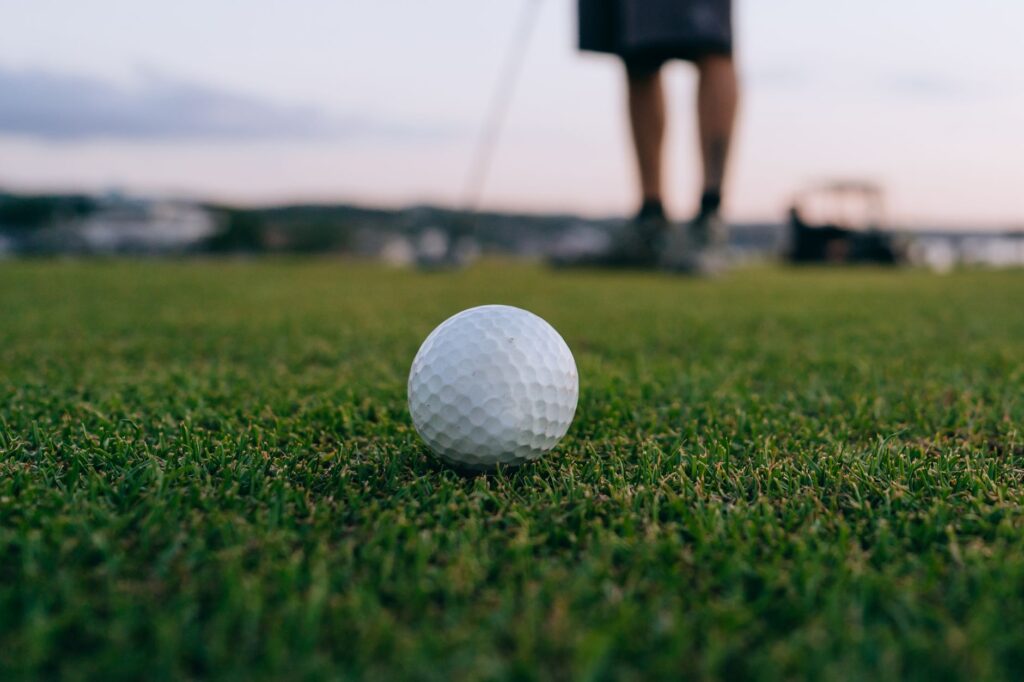 A close-up of a golfer preparing to putt on the green — Dungeness Golf tips