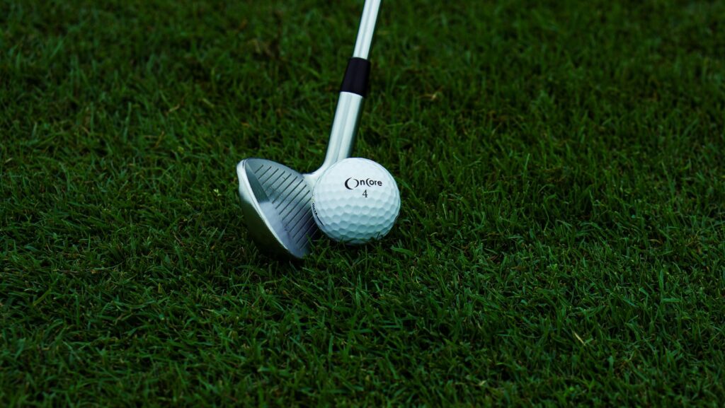 A close-up of golf clubs lined up for a shot to improve golf shot accuracy.