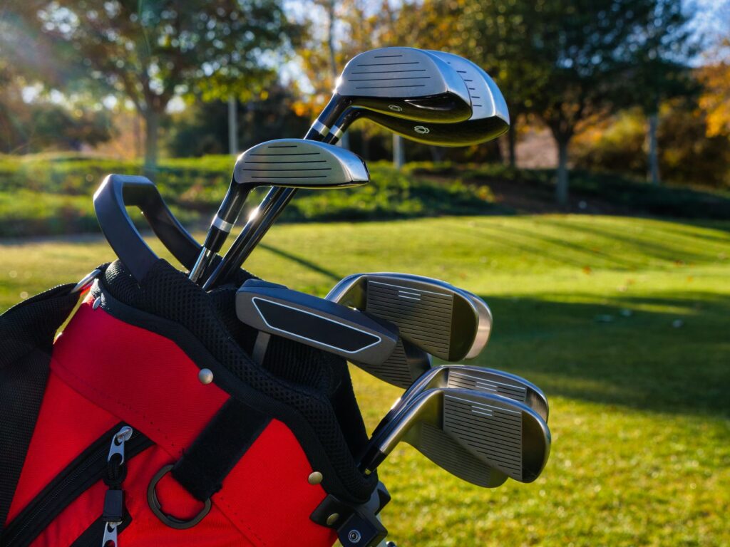 A close-up of golf equipment set against a scenic backdrop — Dungeness golf tournaments