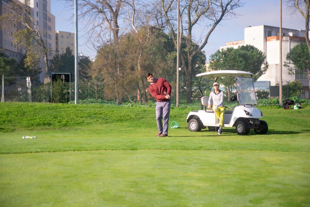 A coach and student reviewing video analysis of a golf swing. — improve golf swing Dungeness