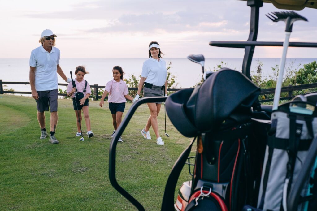A family enjoying a round of golf on a sunny day in Dungeness. — family-friendly golf Dungeness