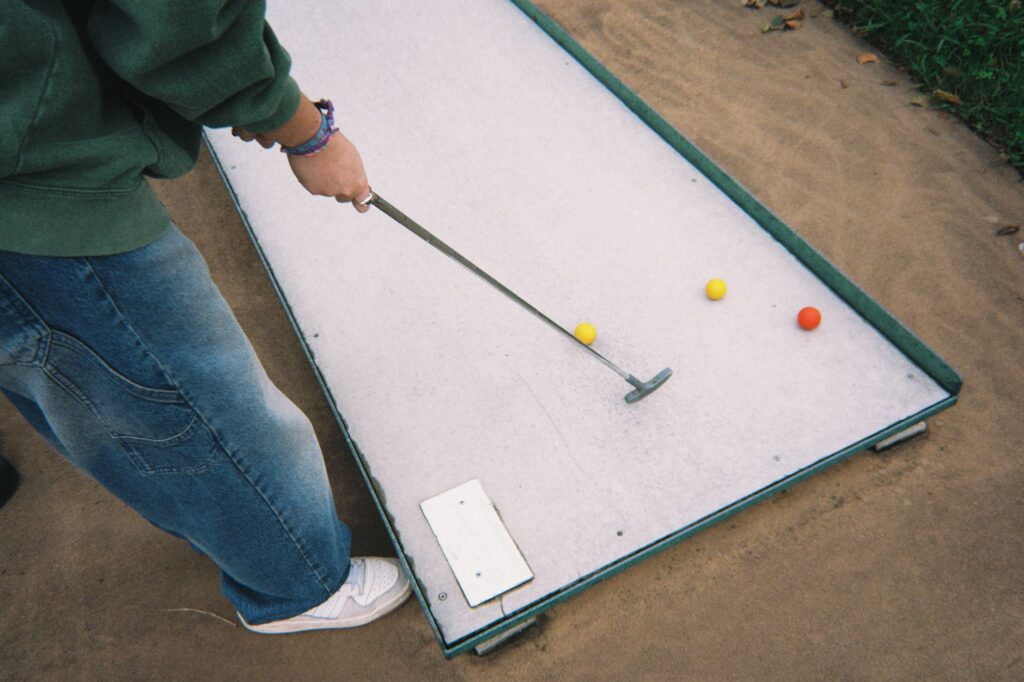 A family enjoying a round of mini golf in Dungeness. — family golf Dungeness