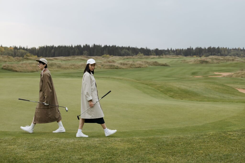 A golfer adjusting their cap against strong winds at Dungeness — golf equipment Dungeness