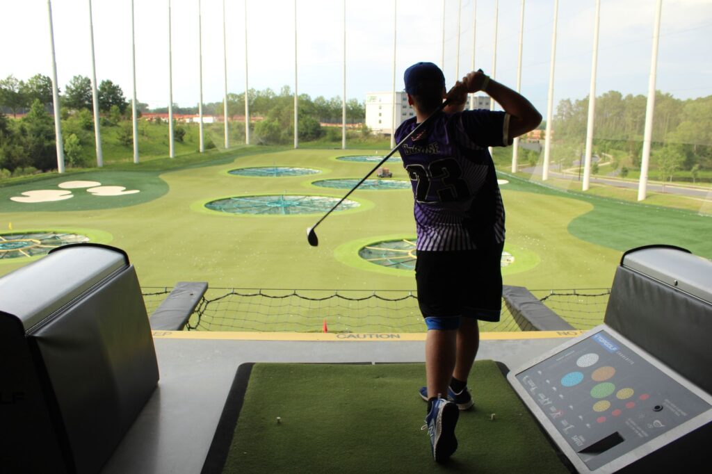 A golfer practicing with a swing analysis tool or app. — golf swing secrets