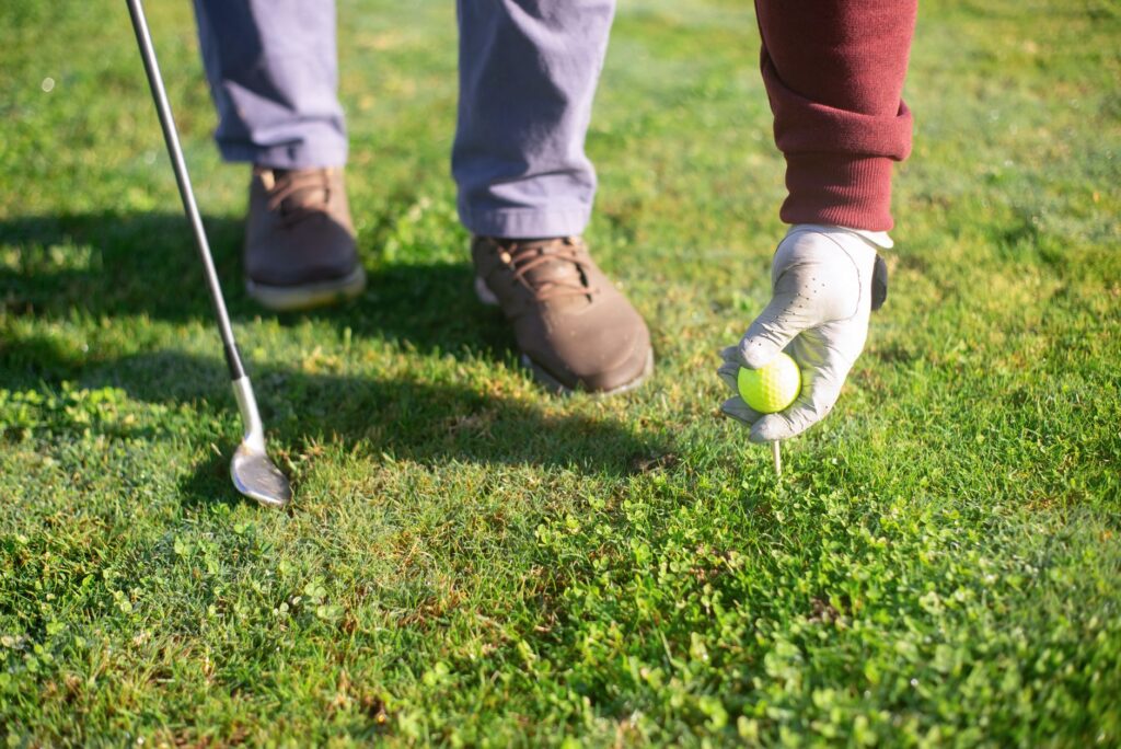 A golfer preparing to tee off, highlighting proper stance and etiquette. — golfing etiquette Dungeness