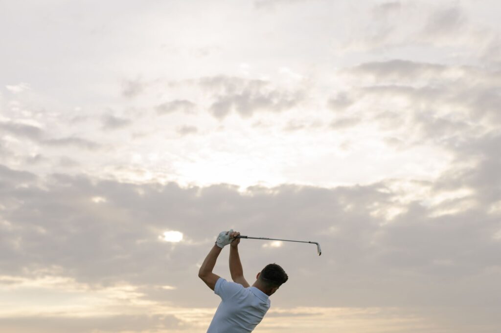 A golfer swinging a club in Dungeness weather conditions — golf equipment Dungeness