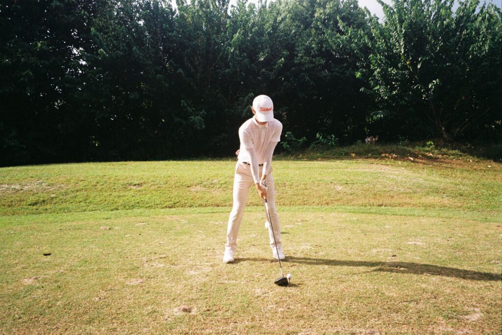 A golfer wearing weather-appropriate clothing while teeing off. — golf equipment for Dungeness