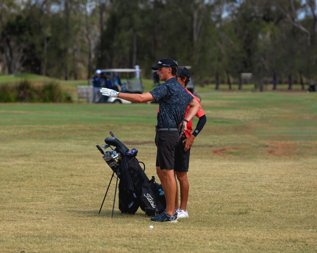 A group of golfers discussing strategy on the course. — Dungeness Golf for beginners