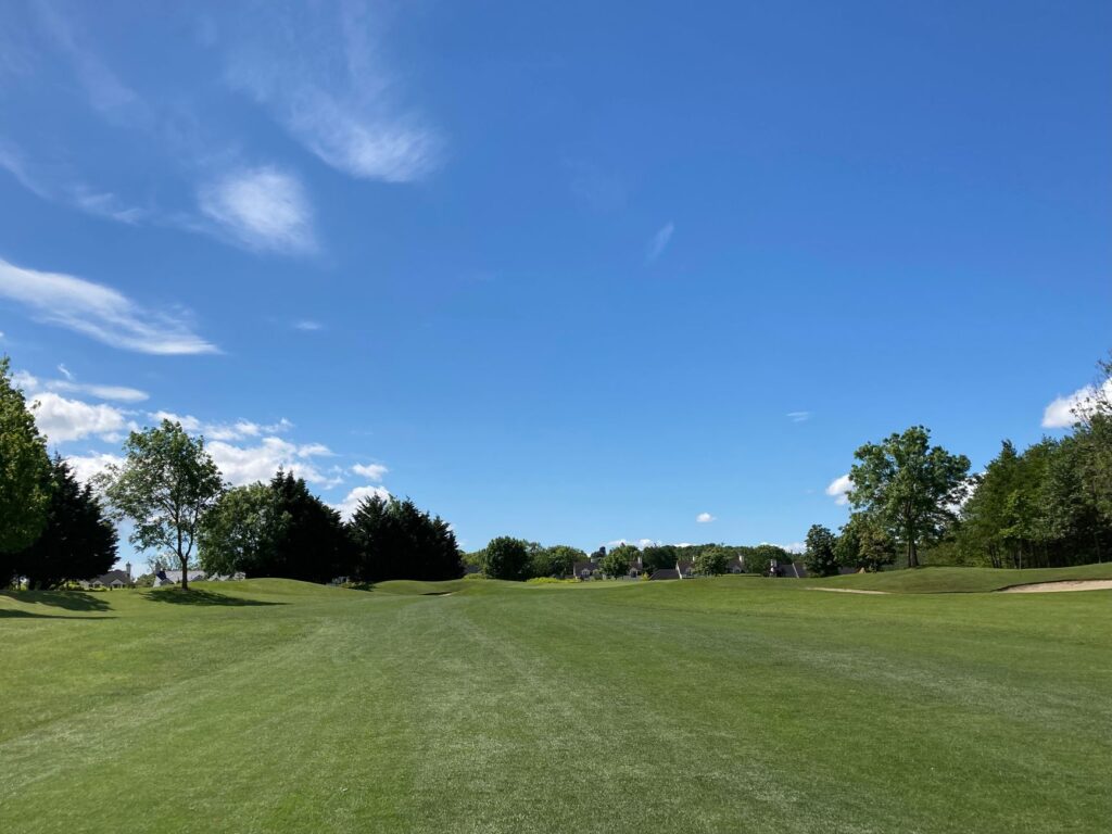 A lush green golf course showing well-maintained turf and greens — golf course maintenance Dungeness
