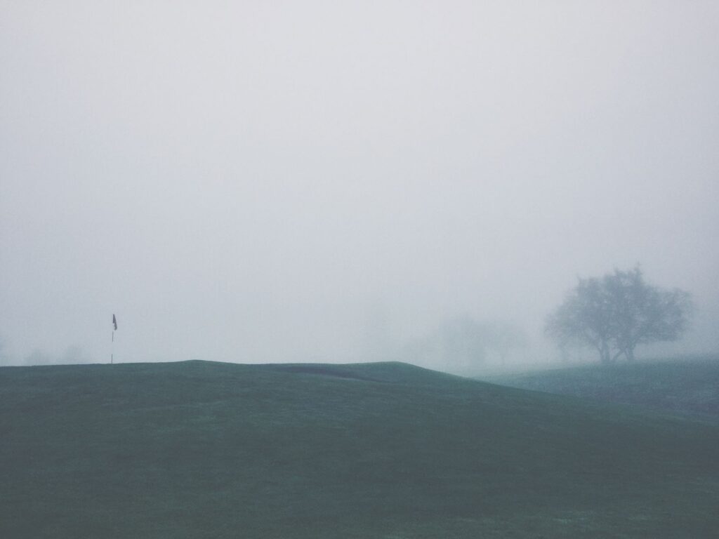 A misty winter morning on the Dungeness golf course with frost-covered grass. — best time to play golf Dungeness