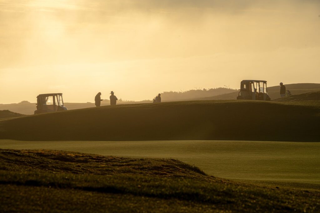 A scenic sunset over a Dungeness golf course with families playing — family golf Dungeness
