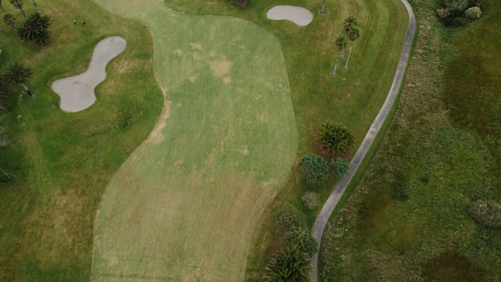 A scenic view of the Dungeness golf course under the summer sun — summer golfing tips Dungeness