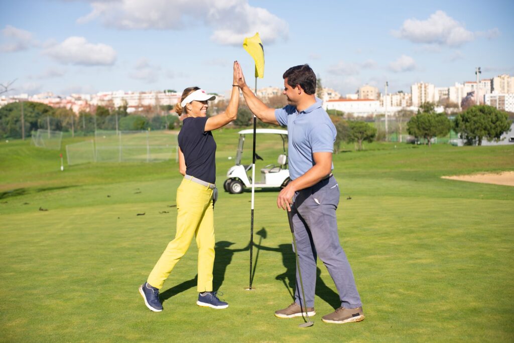 A smiling beginner golfer celebrating a good shot — Dungeness golf courses for beginners