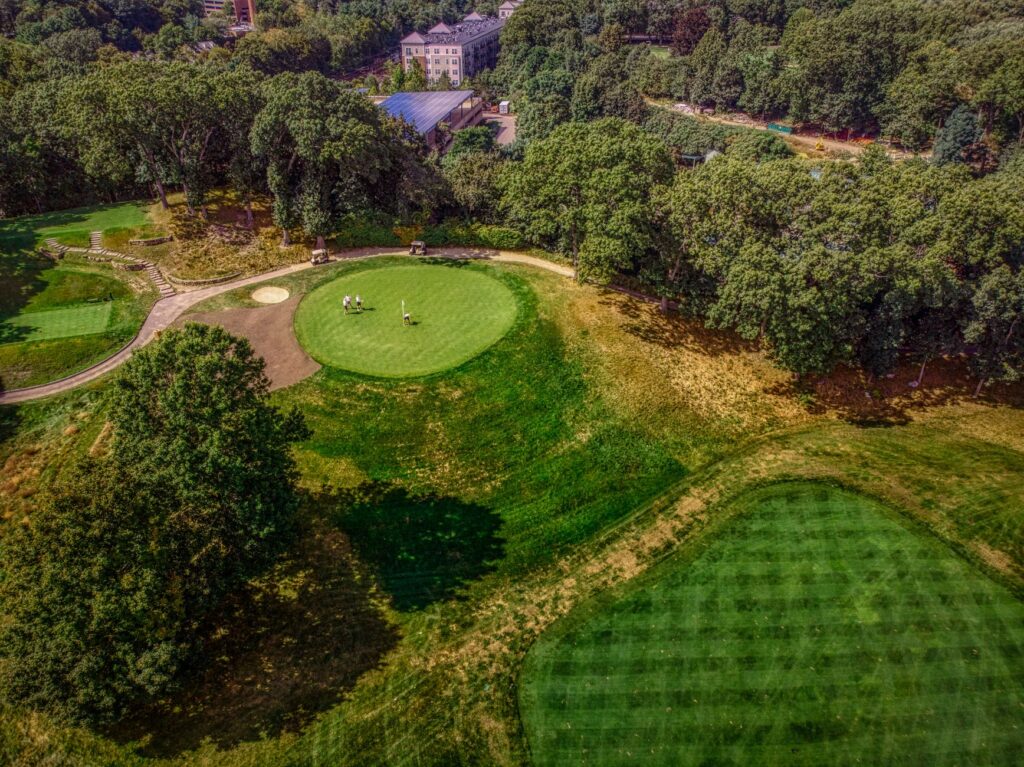 A stunning aerial view of one of the top golf courses near Dungeness, showcasing lush greens and the coastline.