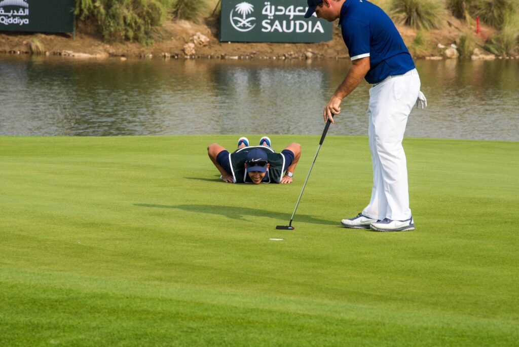 A team of golfers discussing their strategy before a tournament. — golf tournament strategy