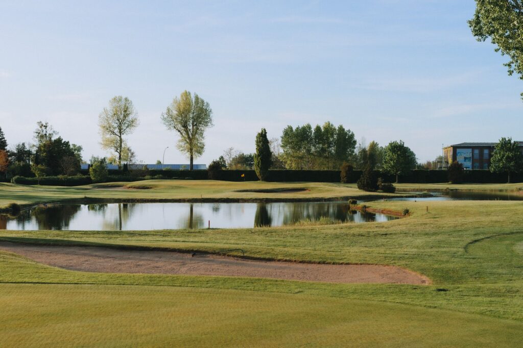 An irrigated golf course during a sunny day, showcasing water management — golf course maintenance Dungeness