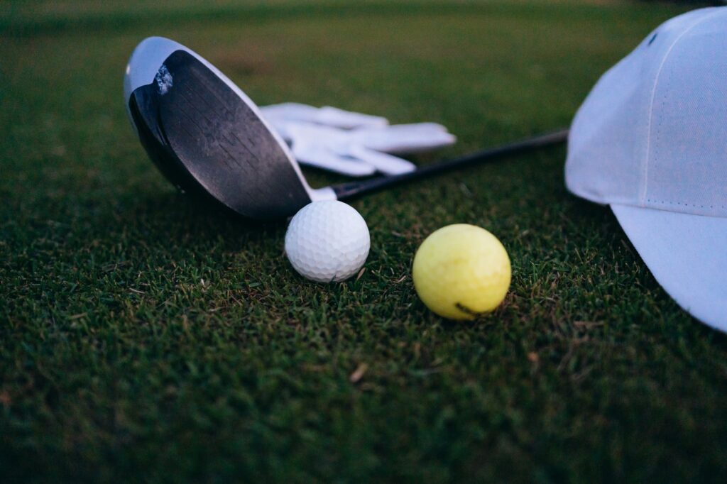 Golf accessories displayed with Dungeness course background. — choosing golf clubs Dungeness