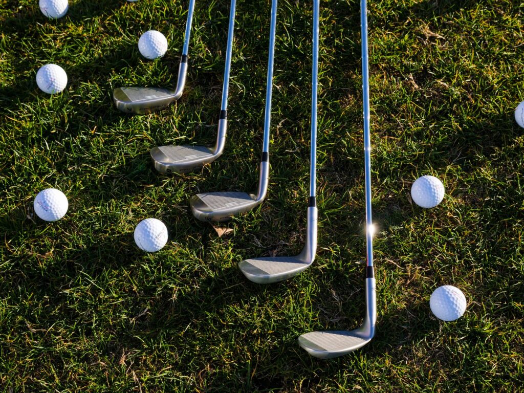 Golf clubs and balls neatly arranged for a beginner's practice session. — beginner golf Dungeness