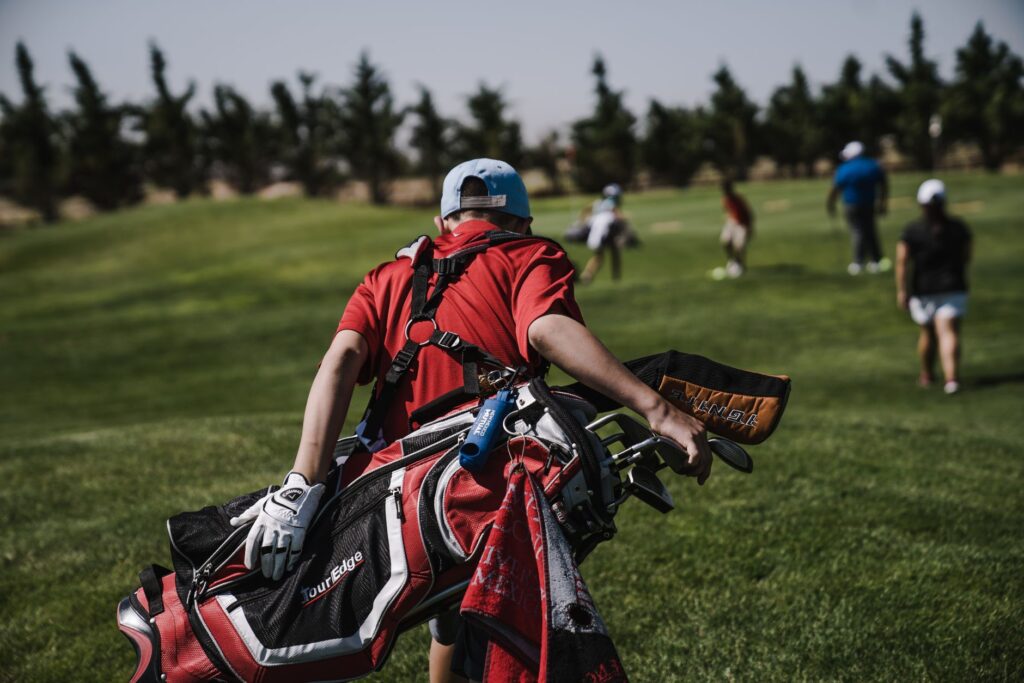 Golfers wearing weather-resistant apparel during a Dungeness round. — golf equipment Dungeness