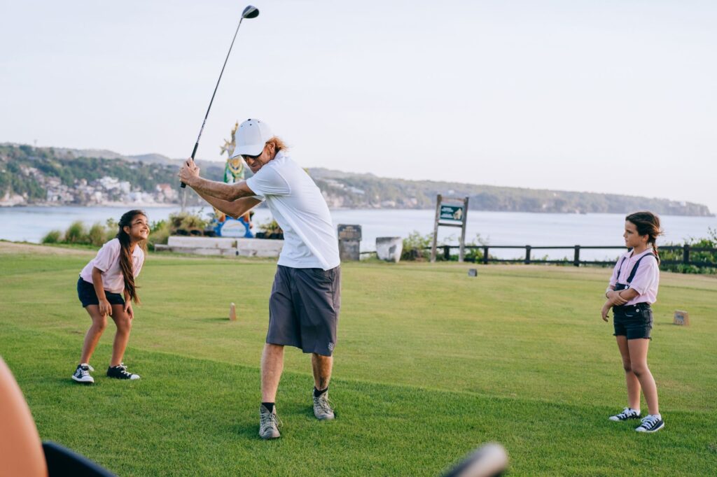 Kids participating in a golf clinic in Dungeness, engaging with a coach. — family golf Dungeness